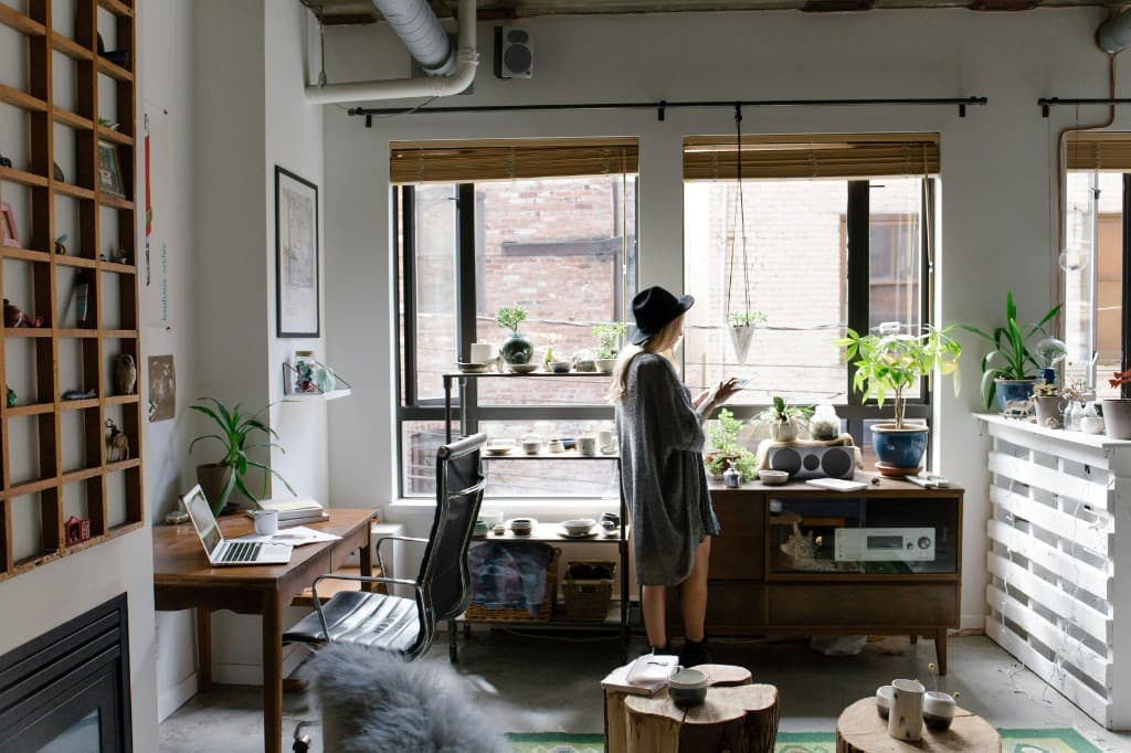 Person checking a tablet in a bright home