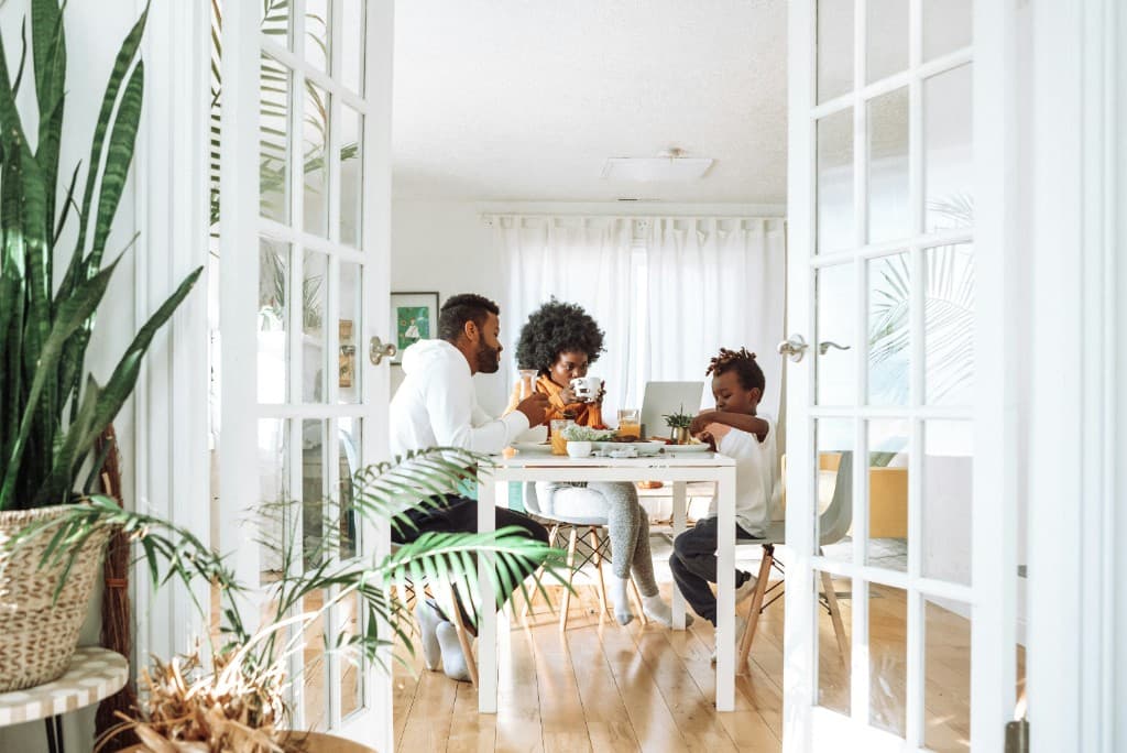 Family sharing a meal together in a bright dining room